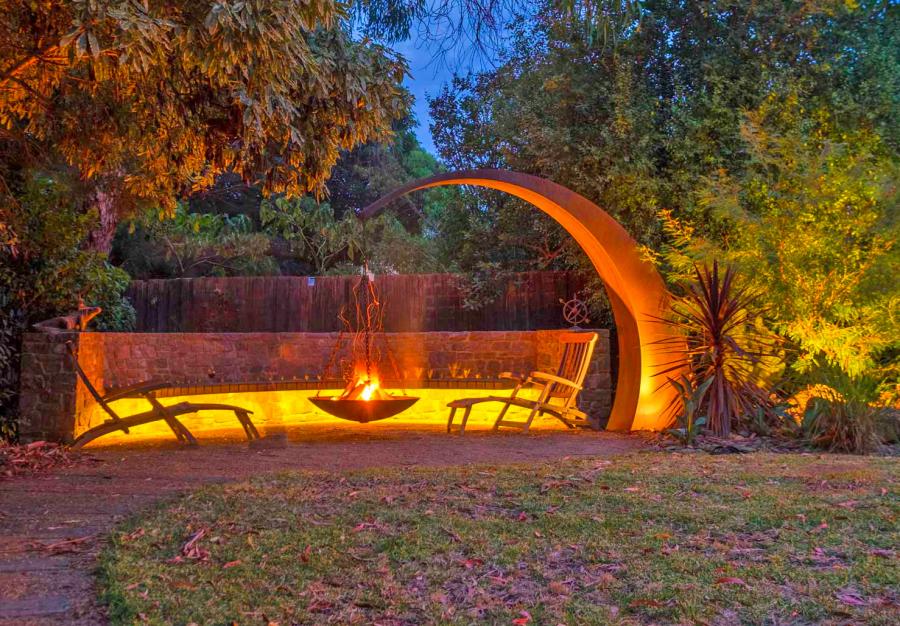 This Hanging Fire Pit Is Held Up With A Giant Arching Metal Beam