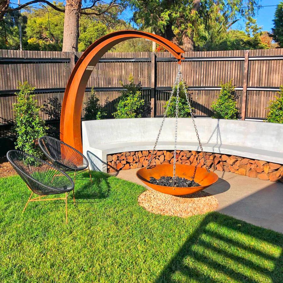 This Hanging Fire Pit Is Held Up With A Giant Arching Metal Beam