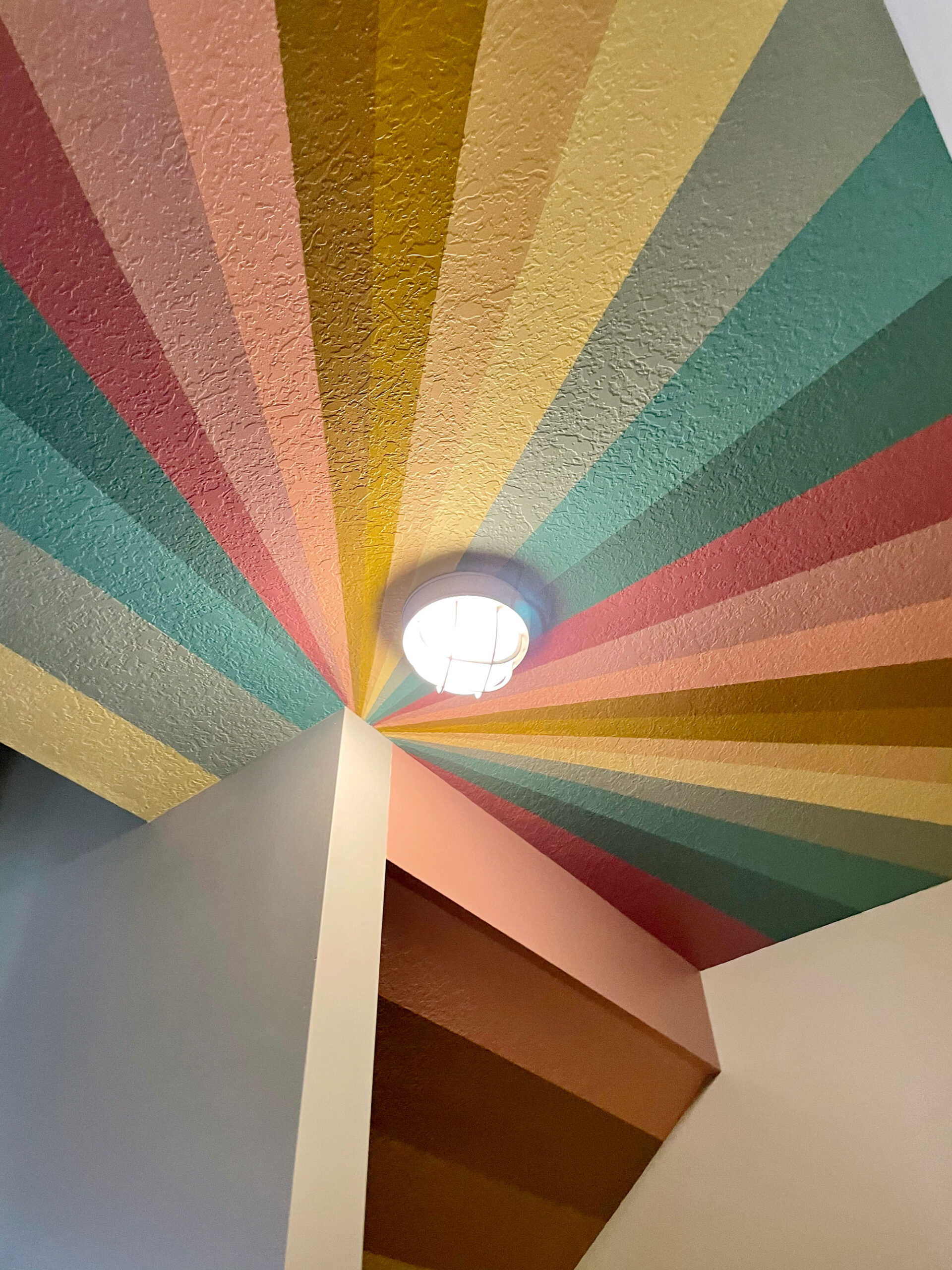 A colorful rainbow under the stairs secret clubhouse mural! ) oh yay