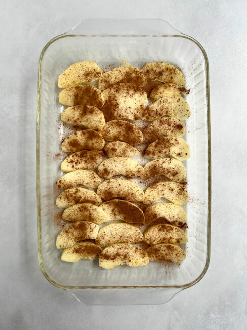 First layer of apple matzo kugel in a glass pan.