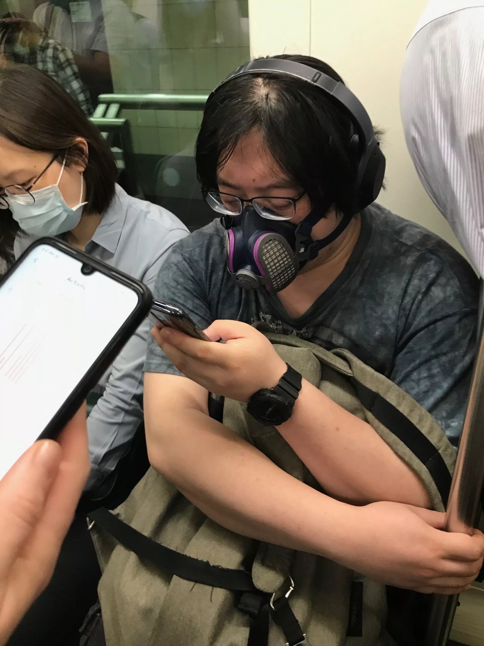 Guy wearing an intense mask on Shanghai metro.