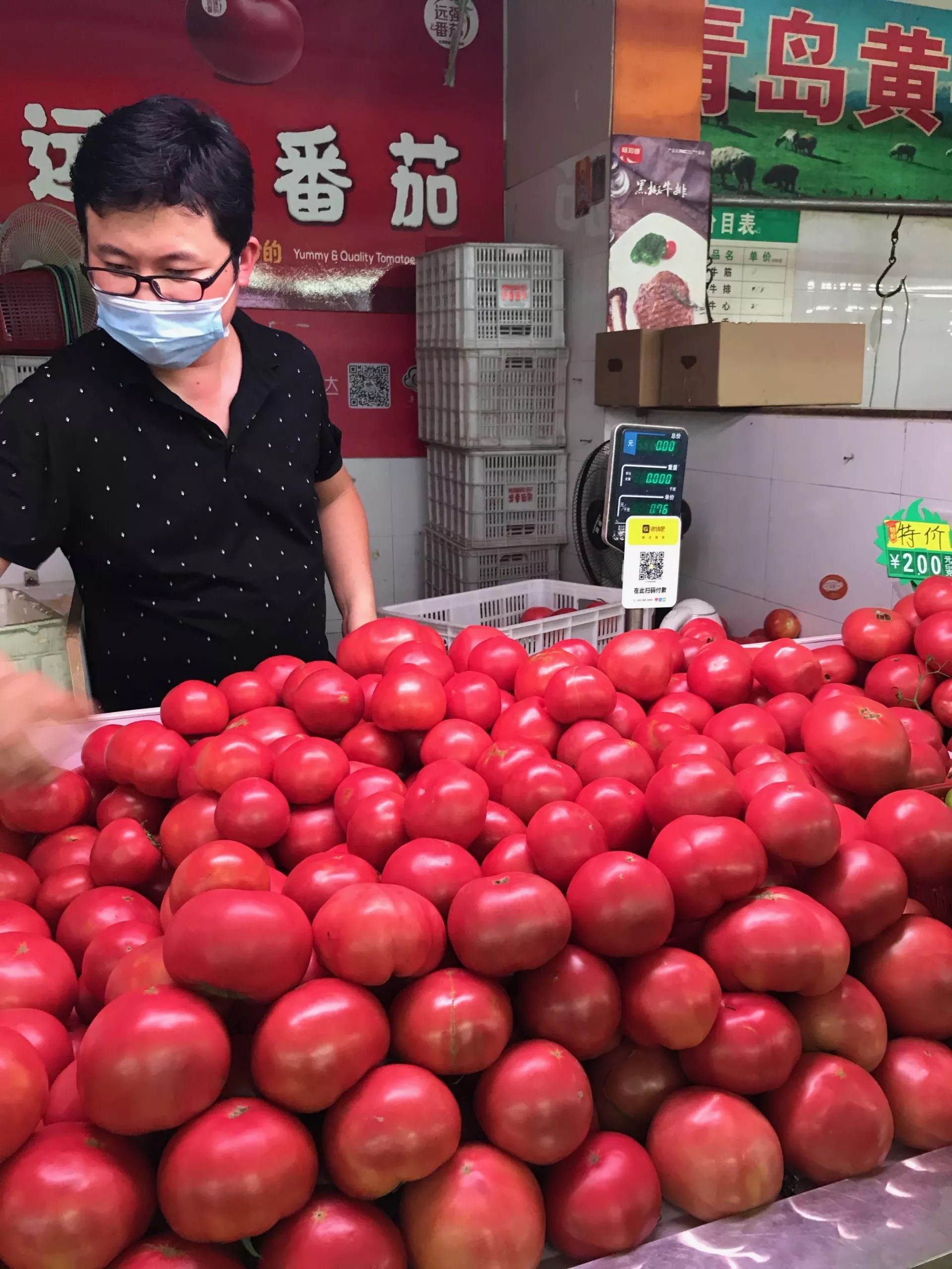 man selling tomatoes in Shanghai wet market