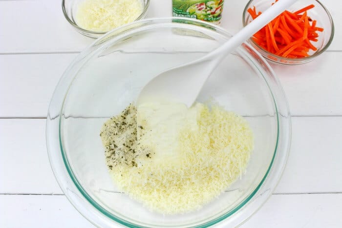 Cheese and spices being mixed in a bowl