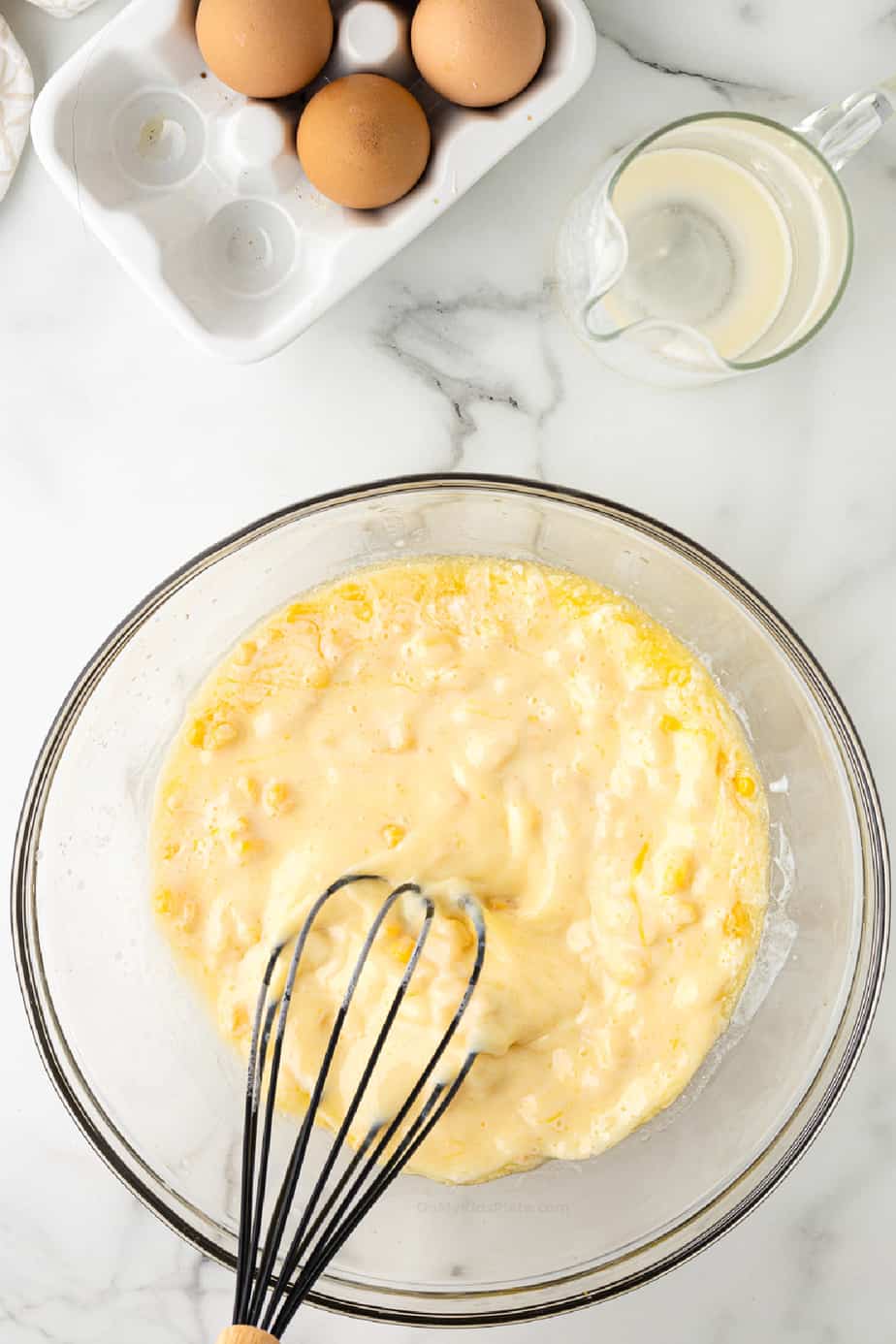 Cornbread batter being mixed in a bowl