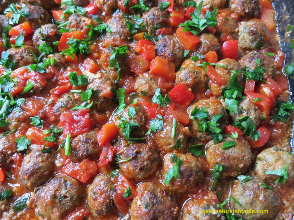 Baked Turkish mini meatballs, koftes in pepper and tomato sauce Ozlem