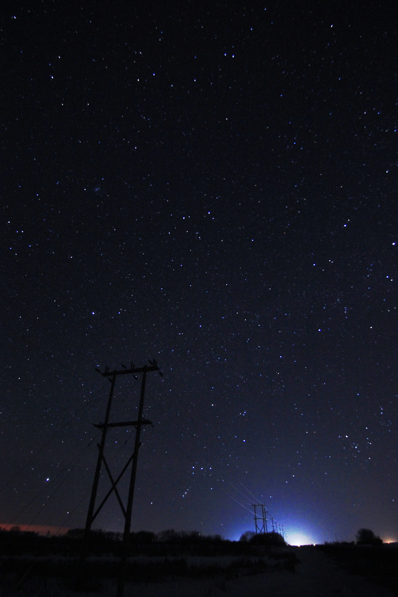 Prairies starscape, featuring Orion and a power transmission tower