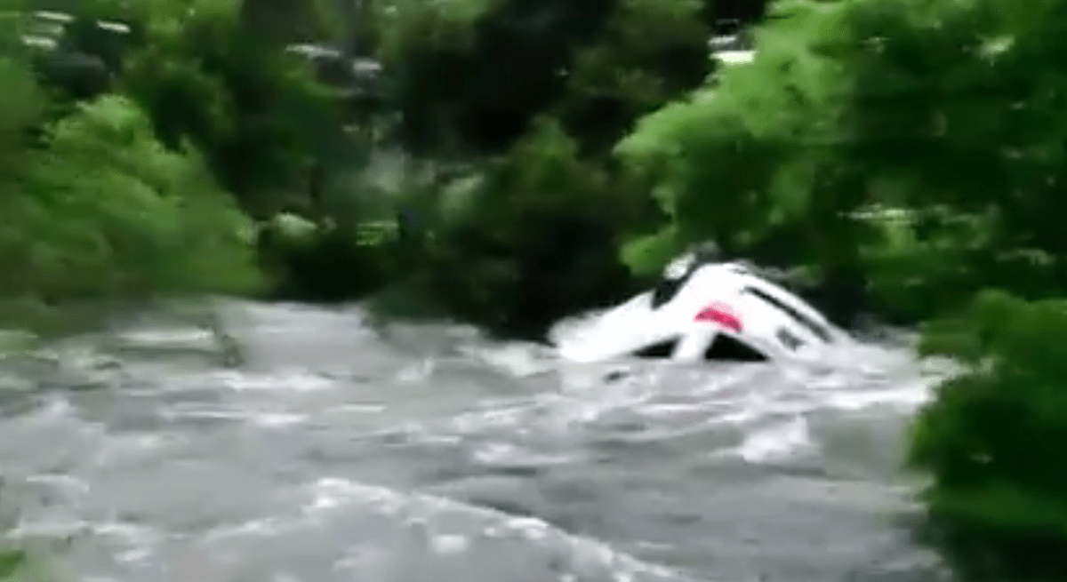 Video appears to show a car being swept away by flood waters near