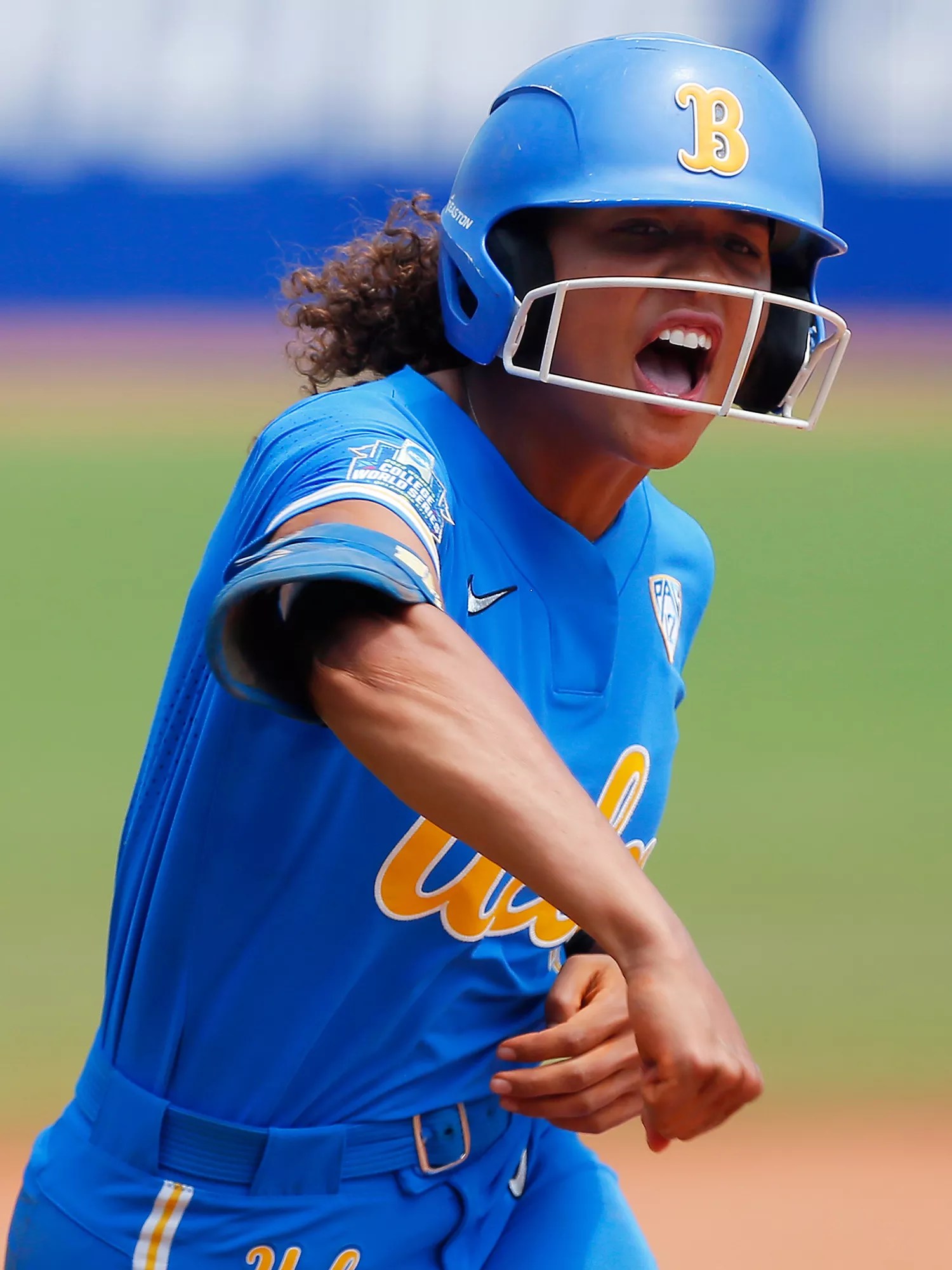 Maya Brady #7 of the UCLA Bruins pumps her fist as she rounds third base with a three-run home run against the Oklahoma Sooners