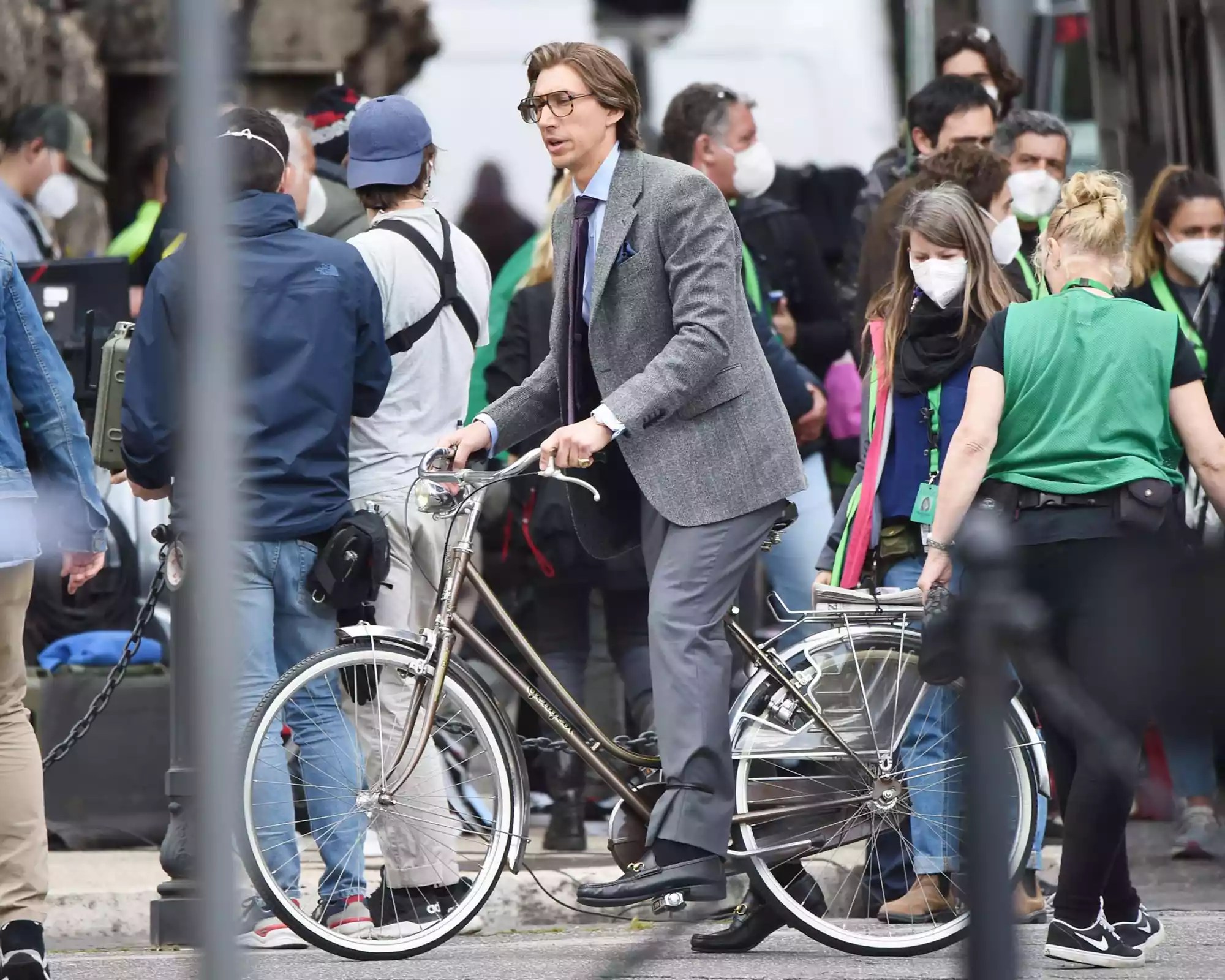 Adam Driver riding a bicycle on The Gucci House movie