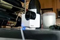 The Petcube Cam 360 placed placed on a kitchen countertop