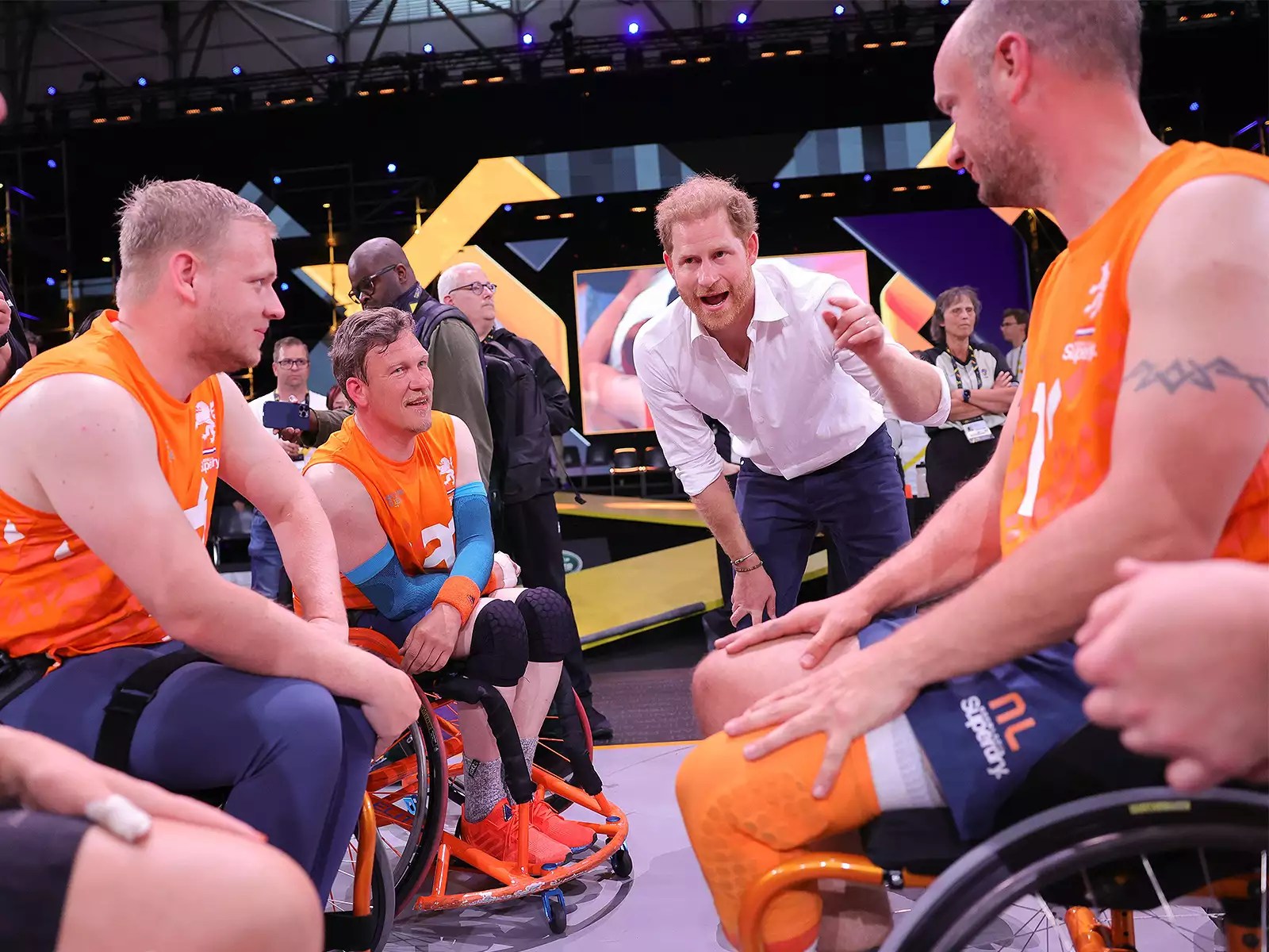 Prince Harry, Duke of Sussex talks to injured member of Team Netherlands basketball team, former Marine Jelle van Der Steen who was operated on last week and brought specially to be able to support his teammates during the Wheelchair Basketball competition during day six of the Invictus Games The Hague 2020 at Zuiderpark on April 21, 2022 in The Hague, Netherlands.