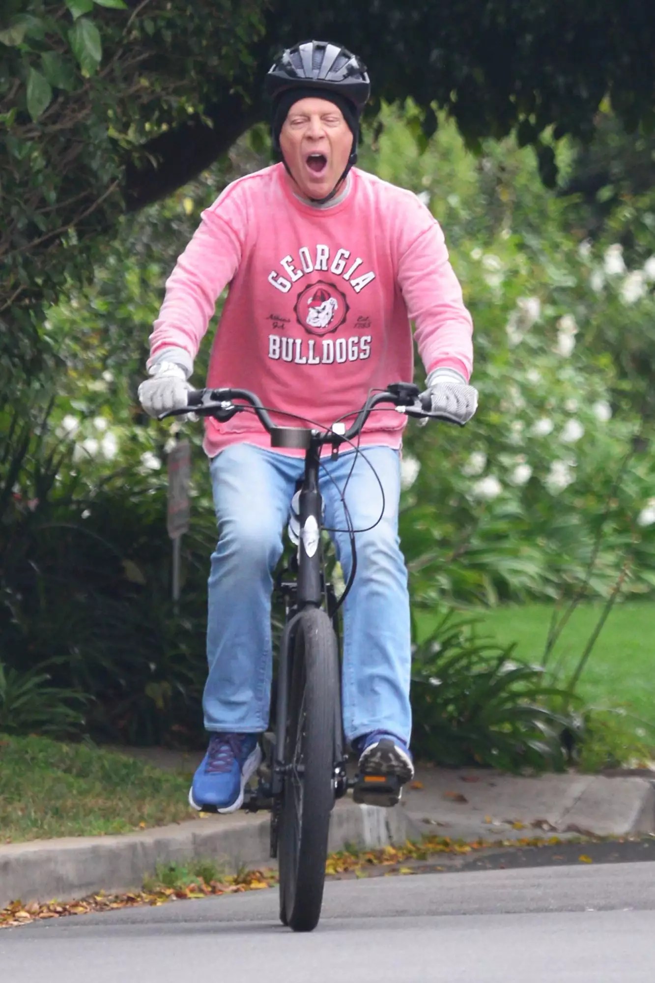 Bruce Willis looks like he is in need of some sleep as he lets out a huge yawn while on an early morning bike ride on his $2k Electric Go Bike through the streets of Brentwood, Ca