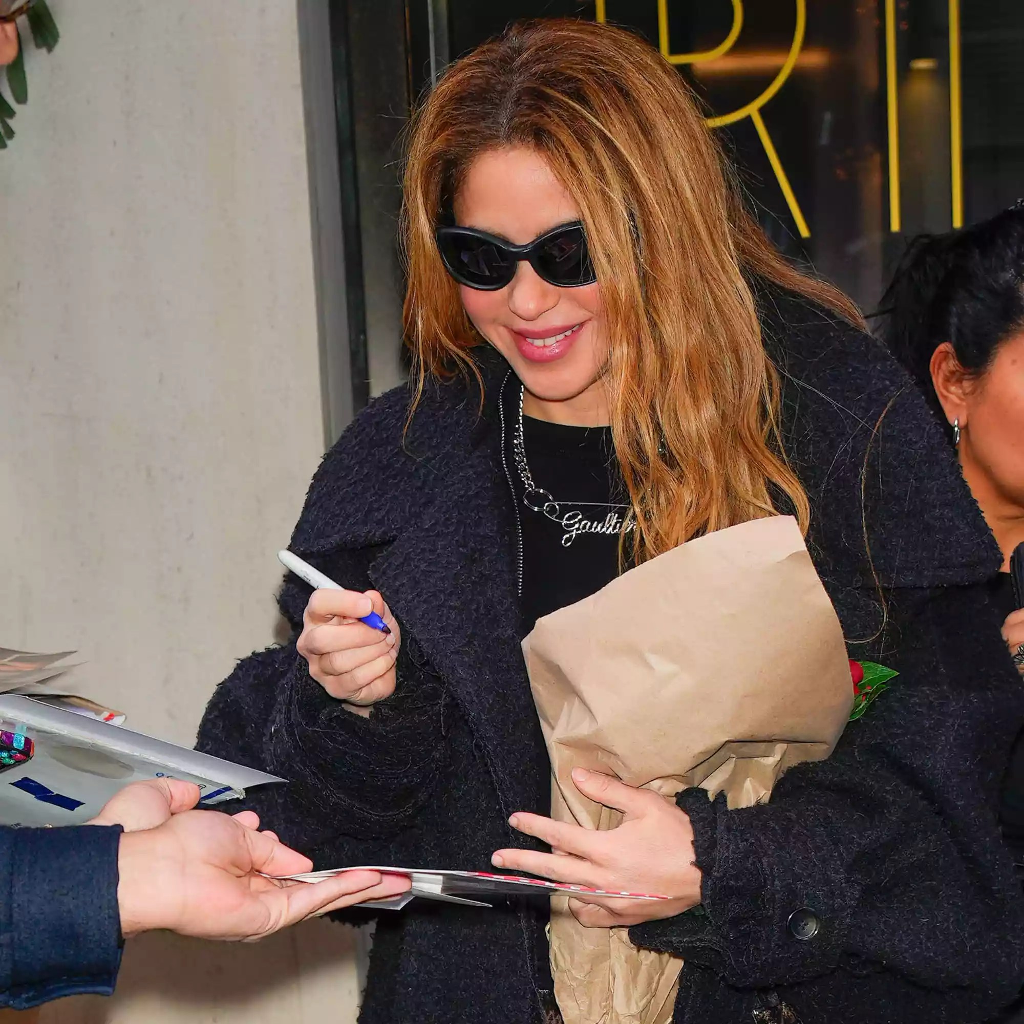 hakira departs her hotel greeting her adoring fans in New York City.
