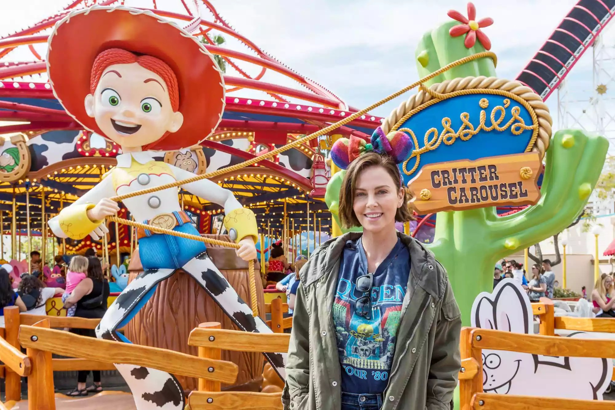 Actress Charlize Theron Poses in Front of Jessie&rsquo;s Critter Carousel at Disney California Adventure Park