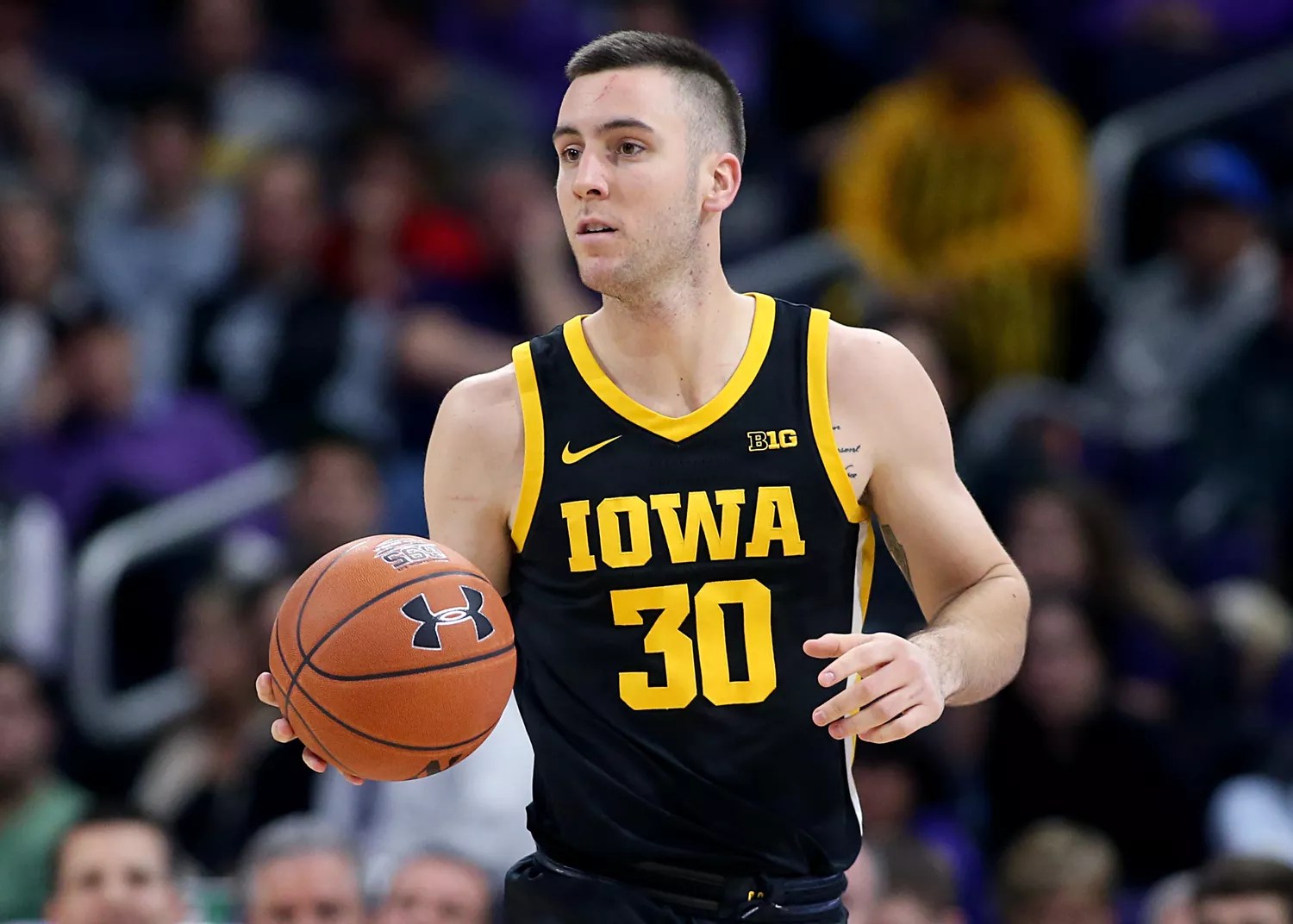 Connor McCaffery #30 of the Iowa Hawkeyes brings the ball up the court in the game against the Northwestern Wildcats at Welsh-Ryan Arena on January 14, 2020