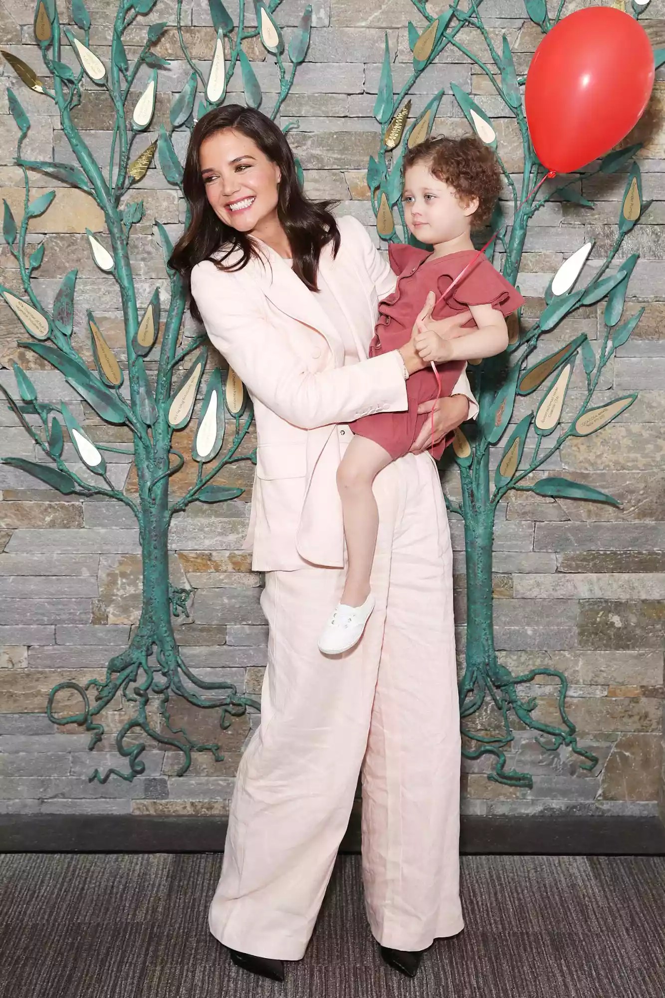 Katie Holmes poses with Ronald McDonald House resident, Ellie Wild during a visit to Ronald McDonald House Westmead on November 15, 2019 in Sydney, Australia