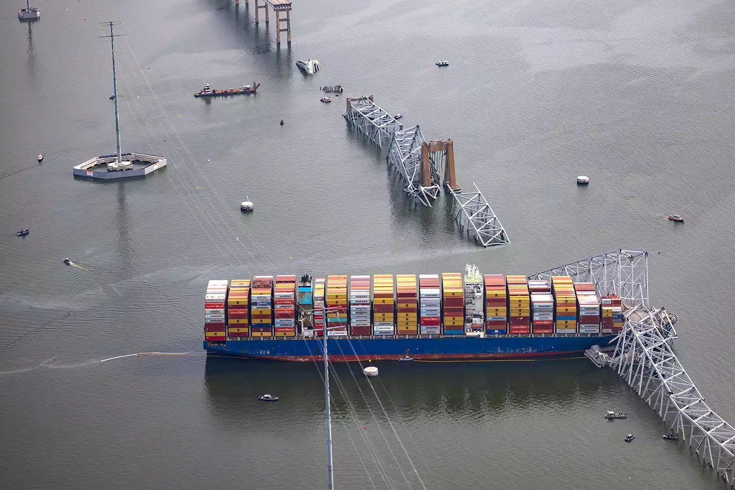 In an aerial view, the cargo ship Dali sits in the water after running into and collapsing the Francis Scott Key Bridge on March 26, 2024 in Baltimore, Maryland.