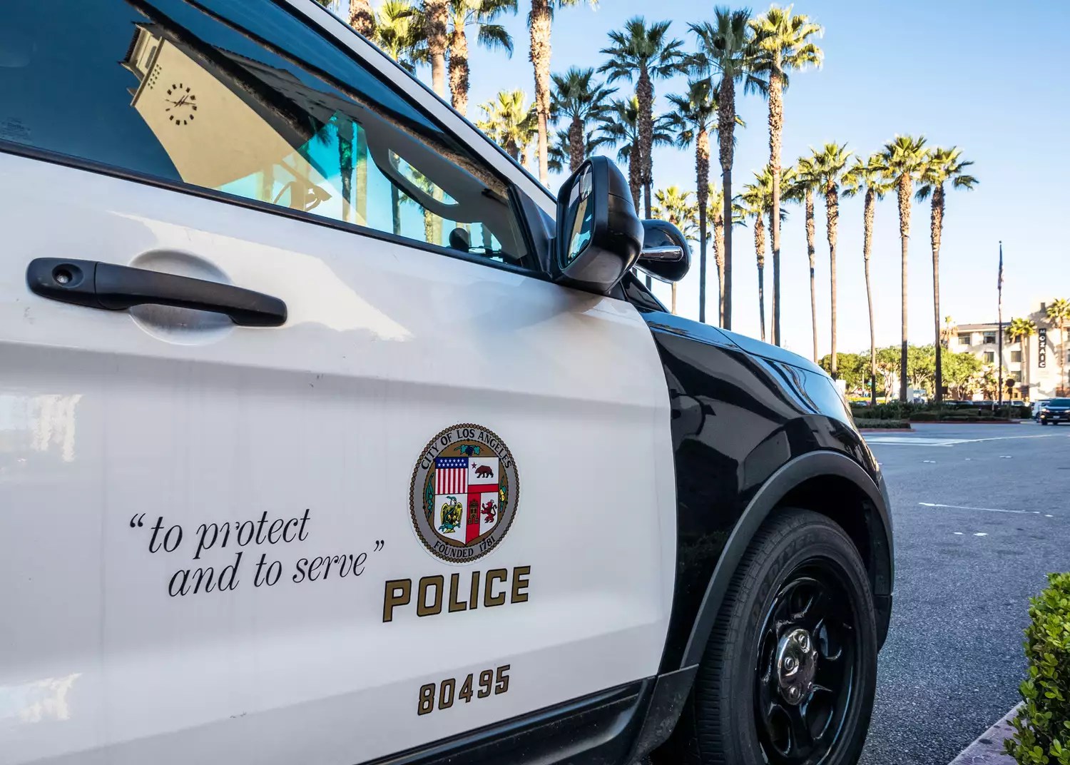 Close-up on the insignia and slogan of a LAPD vehicle