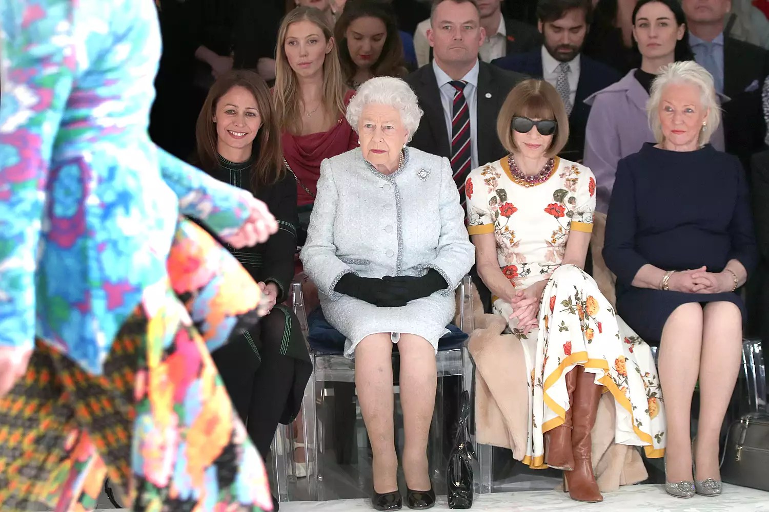 Queen Elizabeth II sits with Anna Wintour, Caroline Rush (L), chief executive of the British Fashion Council (BFC) and royal dressmaker Angela Kelly (R) as they view Richard Quinn&rsquo;s runway show