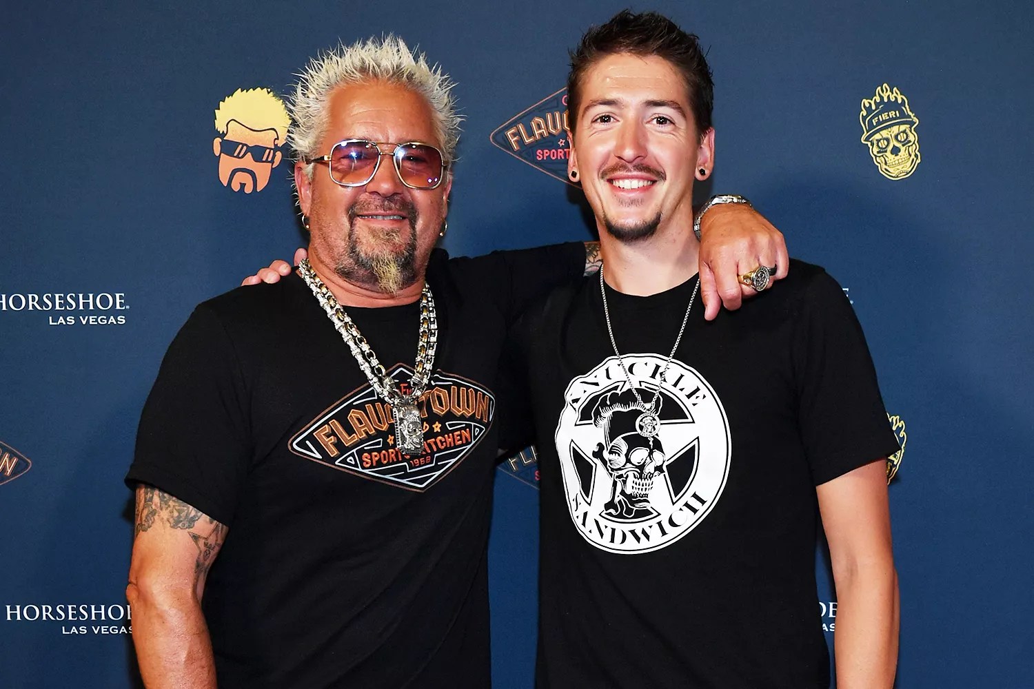 Guy Fieri and his son Hunter Fieri pose on the orange carpet at the grand opening of Guy Fieri&rsquo;s Flavortown Sports Kitchen at Horseshoe Las Vegas on July 07, 2023 in Las Vegas, Nevada.