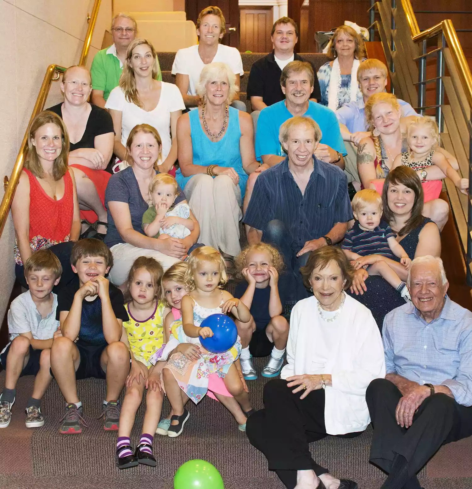 Cater Family Spource: Phil Wise PWISE@emory.edu Top Row: Jay Kelly (husband of daughter Amy Carter), Stephen Reynolds (husband of granddaughter Sarah E), Jeremy Carter (grandson), Annette Carter (wife of son Jeff) u20202nd Row: Amy Carter (daughter), Sarah E Reynolds (granddaughter), Becky Carter (wife of son Chip), Chip Carter (son), Jamie Carter (grandson) u20203rd Row: Kate Carter (wife of grandson Jason), Sarah R Carter (granddaughter) with Keith (great grandson) in lap, Jeff Carter (son) u2020Up from Jeff u00F1 Margaret Carter (granddaughter) with Irie (great granddaughter) in lap u2020Down from Jeff u00F1 Sarah J Carter (wife of grandson Josh) with Charlie (great grandson) in lap u2020Row of Children: Thomas Carter (great grandson), Henry Carter (great grandson), Josephine (great granddaughter), Luella (great granddaughter), Kit (great granddaughter), Errol (grandson) u2020 This photo was taken by Sarah Reiff, Scheduling Assistant, Office of Jimmy Carter, last month (August) at The Carter Center in Atlanta, Georgia.