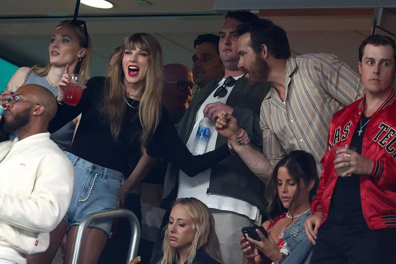 Taylor Swift and Actor Ryan Reynolds talk prior to the game between the Kansas City Chiefs