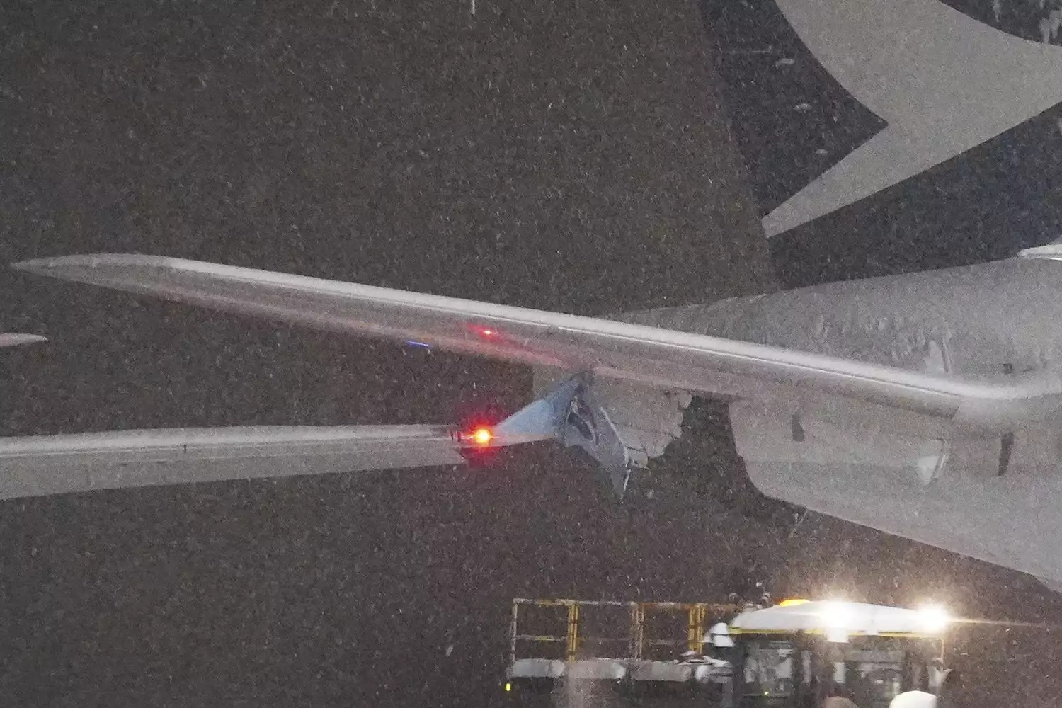 A part of wing of a Korean Air plane, left, and Cathay Pacific aircraft, right, are seen after a collision at northern Japan&rsquo;s New Chitose Airport in Sapporo, Tuesday, Jan. 16, 2024