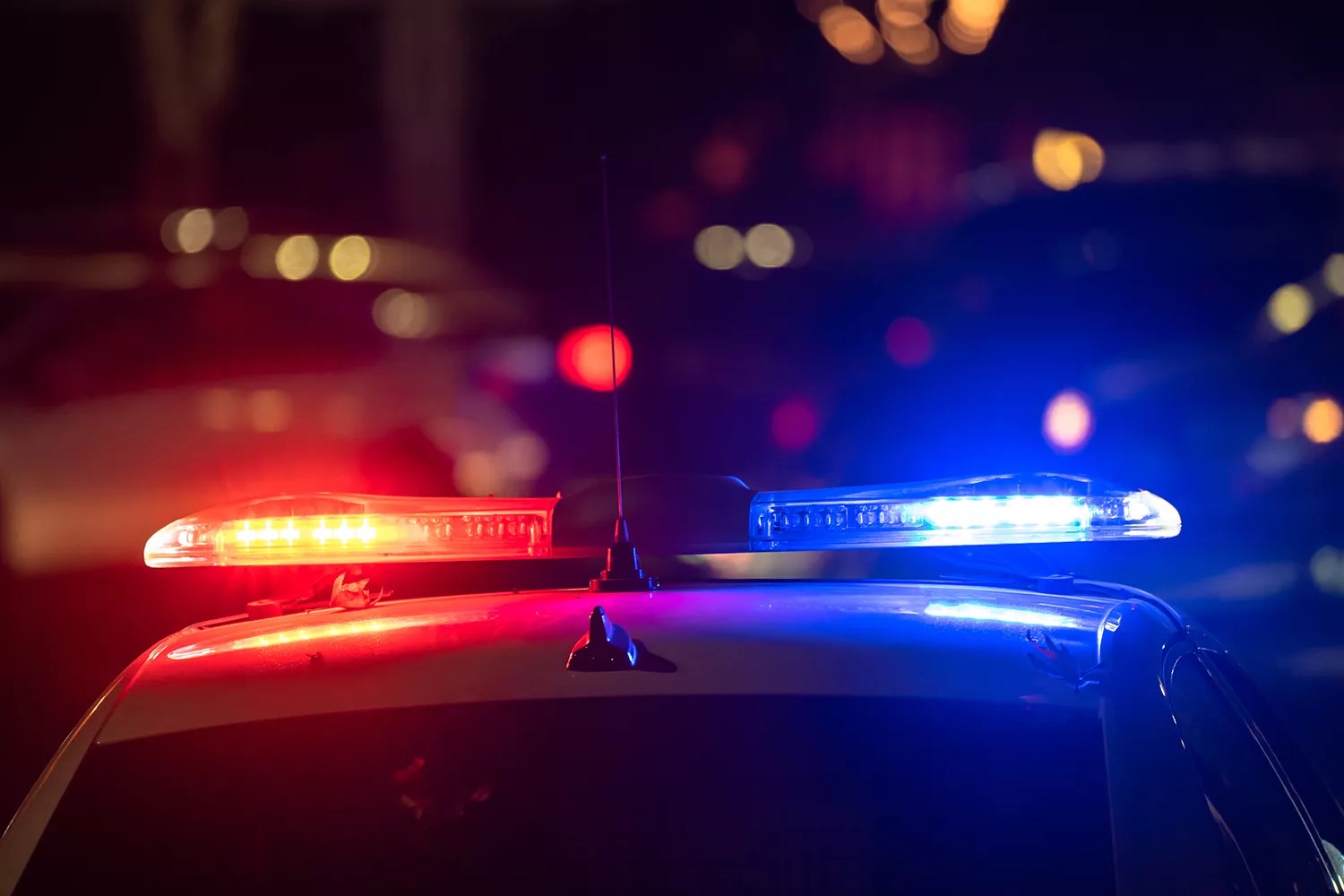 Police car with flashing lights on at night