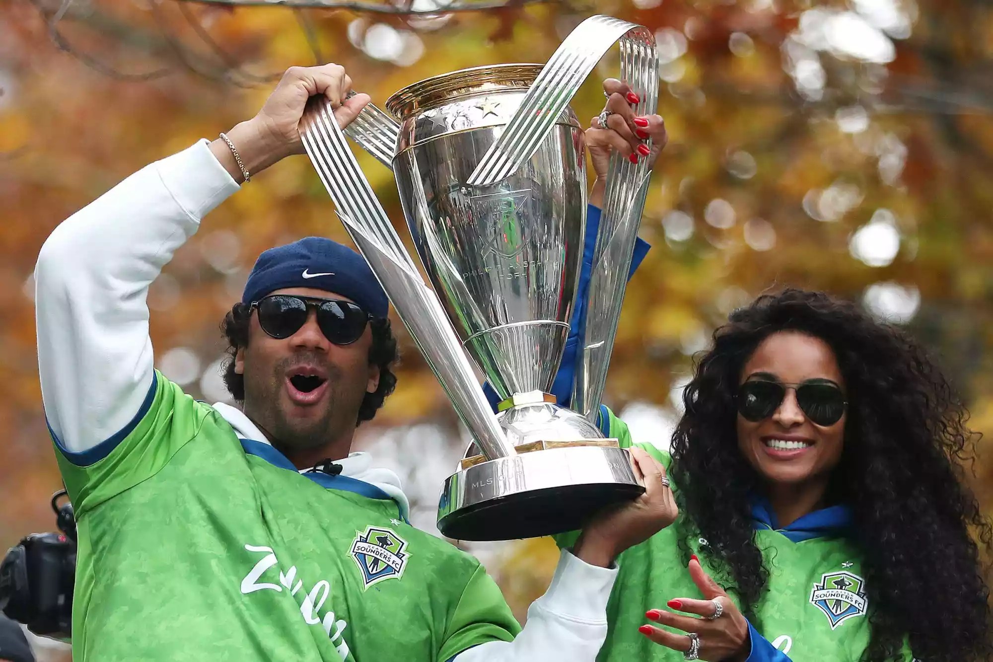 Seattle Sounders part owners Russell Wilson and Ciara show their support for the team during their MLS Cup victory parade on November 12, 2019 in Seattle