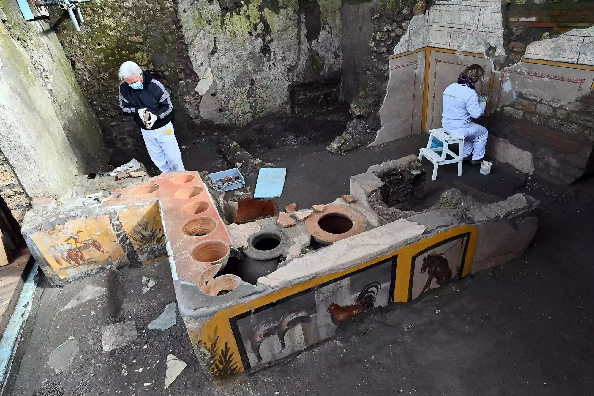 This picture released on December 26, 2020 by the Pompei Press Office shows a thermopolium, a sort of street &ldquo;fast-food&rdquo; counter in ancient Rome, that has been unearthed in Pompei, decorated with polychrome motifs and in an exceptional state of preservation