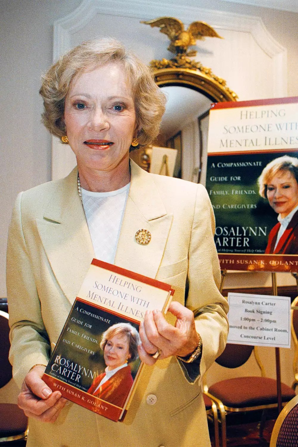 Former first lady Rosalynn Carter holds a copy of her book &lsquo;&lsquo;Helping Someone with Mental Illness&rsquo;&rsquo; during a book signing July 17, 1998 in Washington, DC. (photo by Dave Tracy)