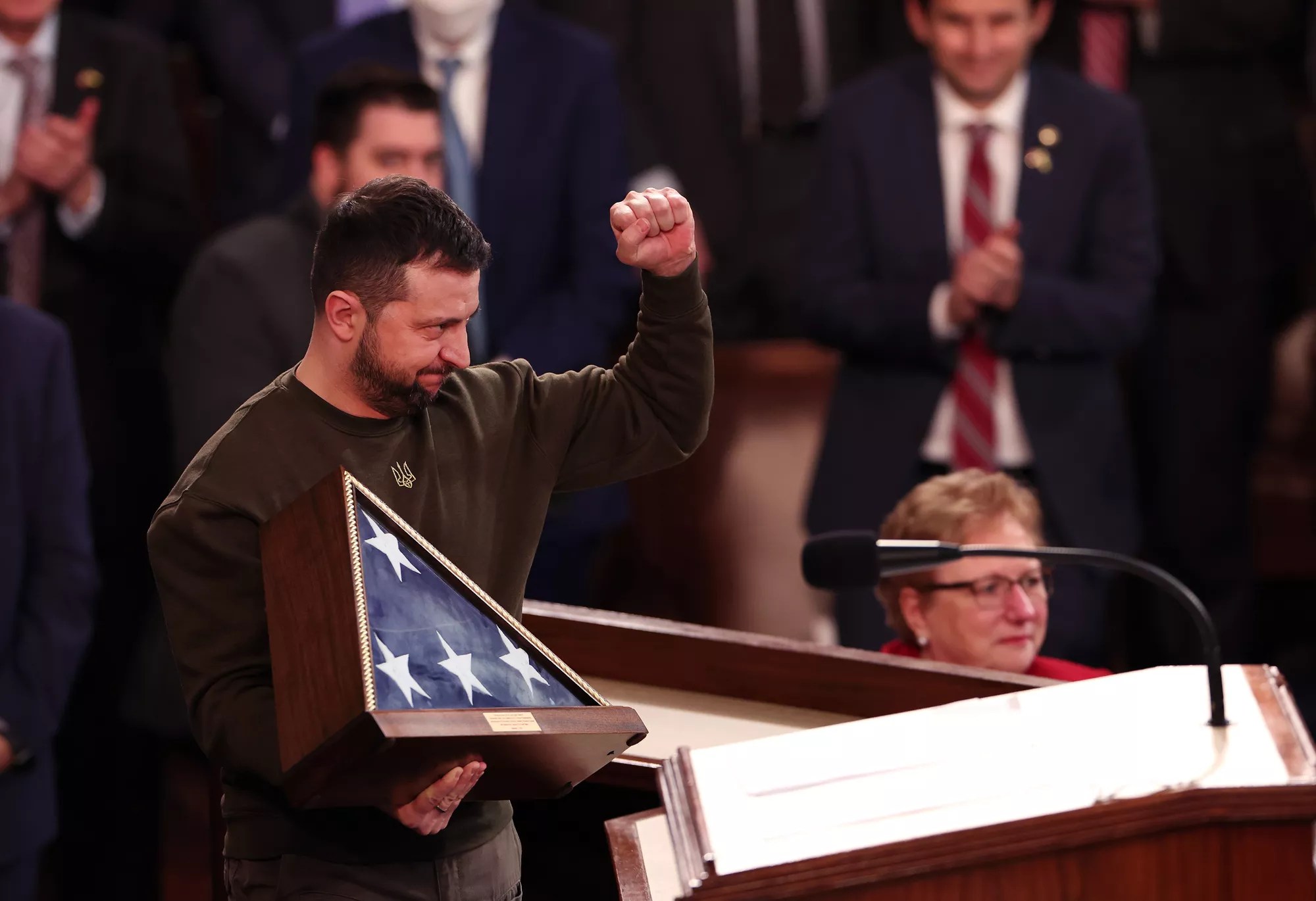 President of Ukraine Volodymyr Zelensky holds an American flag gifted to him by U.S. Speaker of the House Nancy Pelosi (D-CA) as he addresses a joint meeting of Congress in the House Chamber of the U.S. Capitol on December 21, 2022 in Washington, DC. In his first known trip outside of Ukraine since Russia invaded, Zelensky met with U.S. President Joe Biden and outlined Ukraine&rsquo;s request for continued military aid.