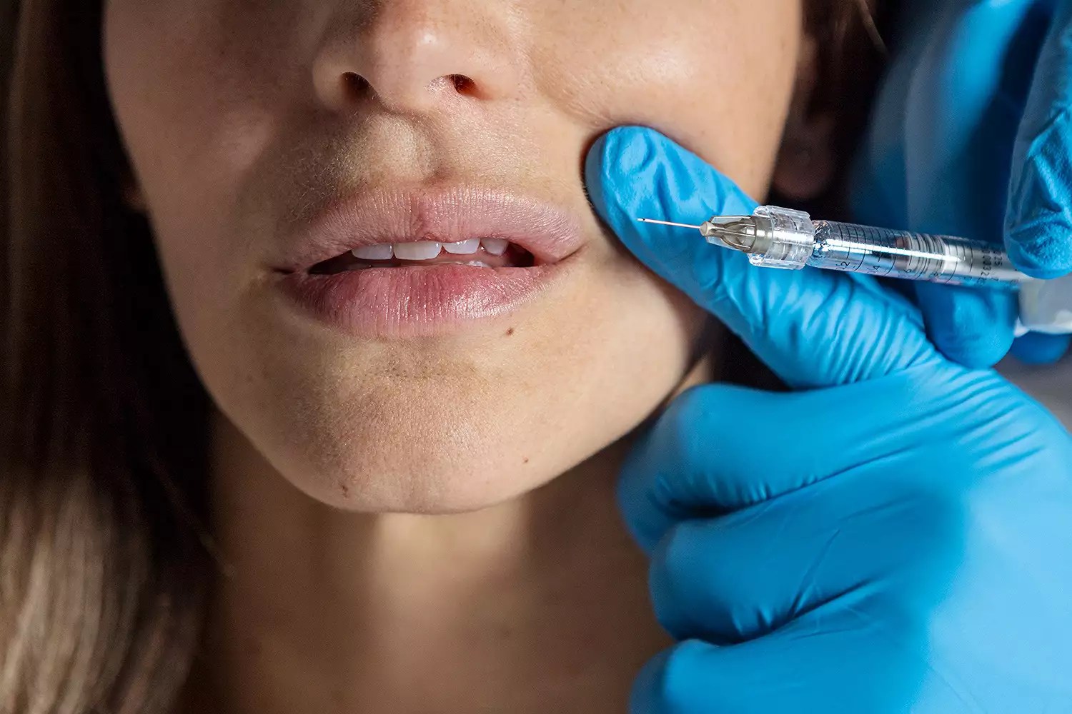 Woman getting lips injected