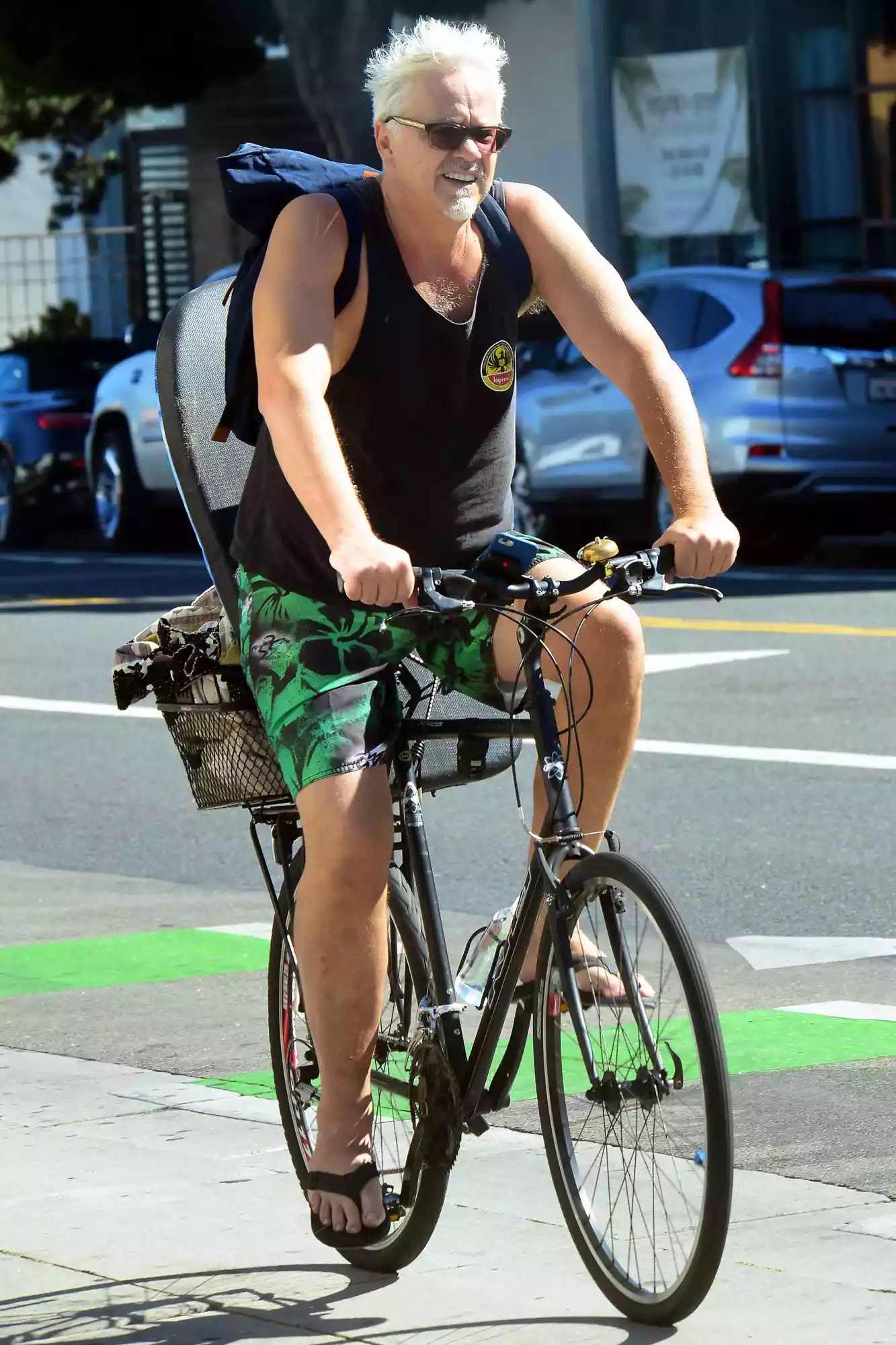 EXCLUSIVE: Tim Robbins embraces the sunny beach life style as he is spotted riding his bike on his way to go Boogie boarding in Santa Monica, Ca