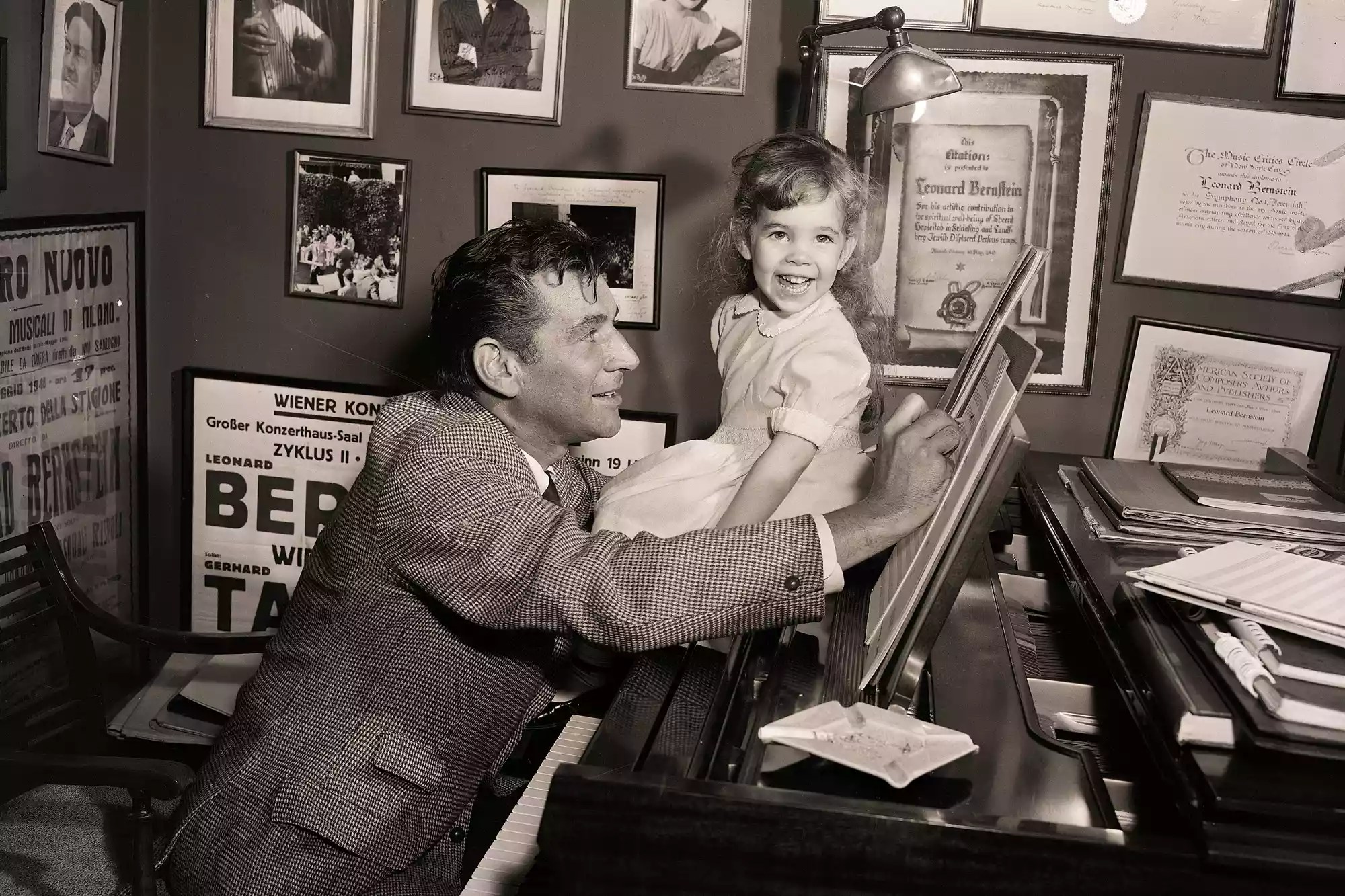 An impudent smile on little Jamie&rsquo;s face as she sits at her father&rsquo;s side when he works at the piano shows she has no awe of the Bernstein genius.