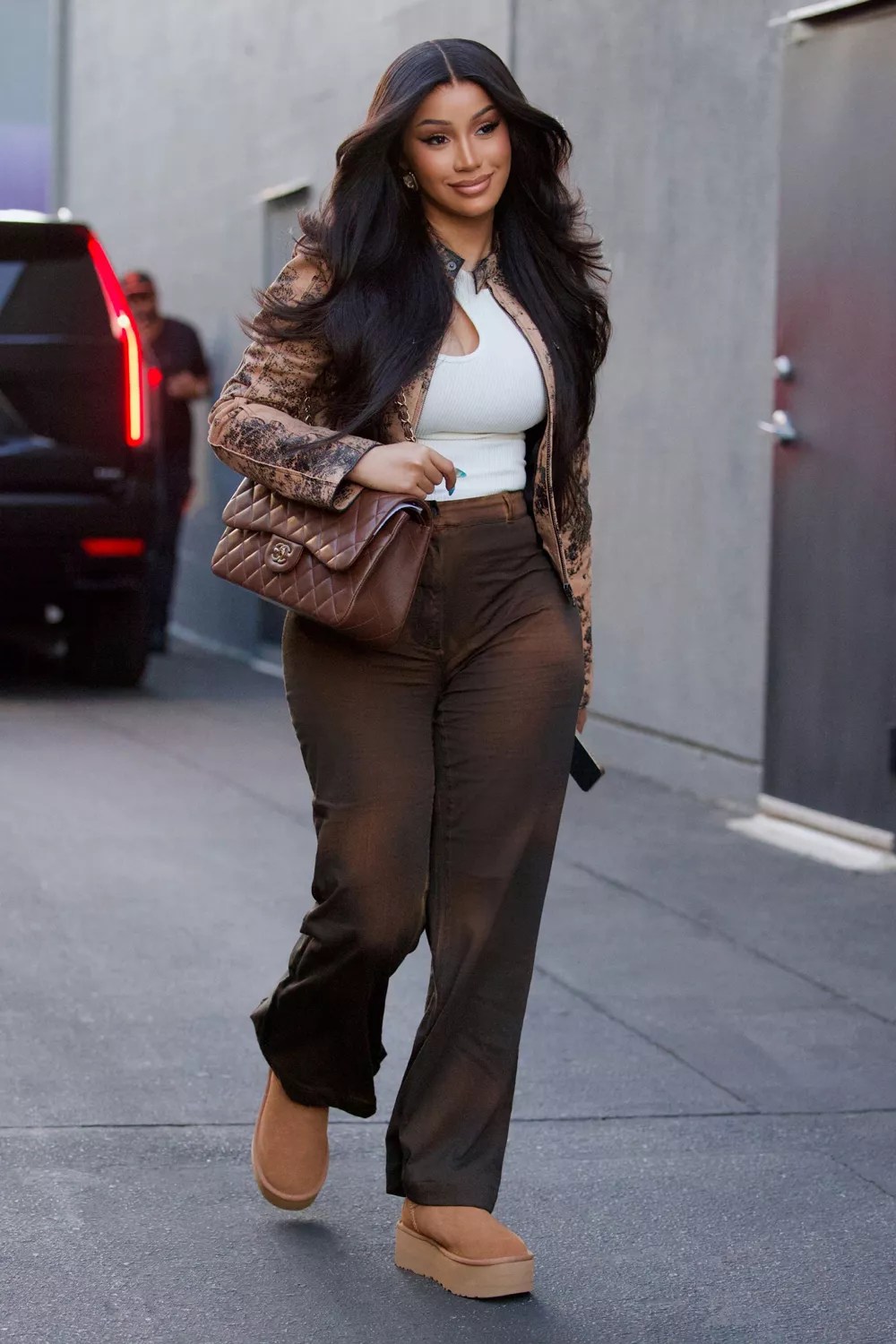 Cardi B was spotted arriving to a rehearsal studio on Thursday evening, looking fashionable in a brown ensemble which she styled with a pair of Ugg boots
