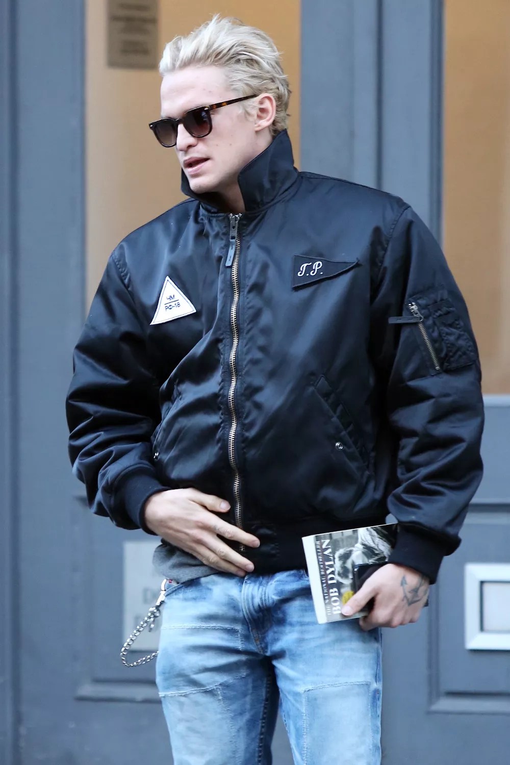 Cody Simpson shopping with a friend in Soho, stopping to get his picture taken by a random woman who asked him if she can take his picture, and then sitting in Washington Square Park reading a book on Bob Dylan