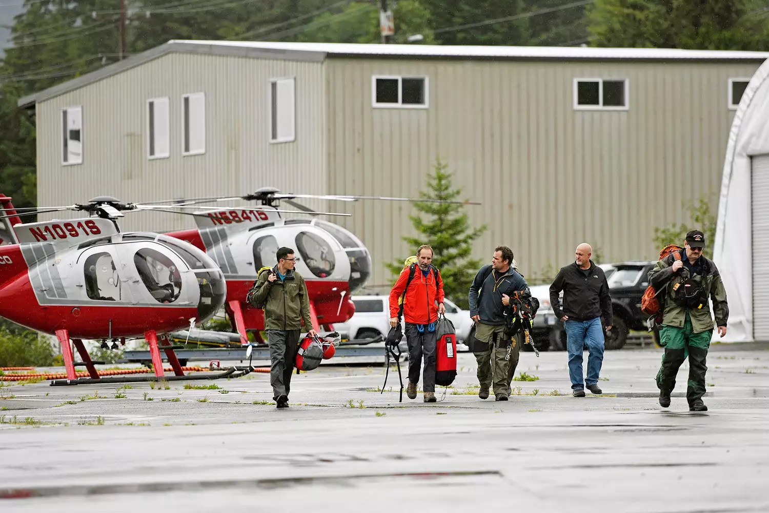 Ketchikan Volunteer Rescue Squad personnel land and disembark from a Hughes 369D helicopter on Thursday, Aug. 5, 2021, at Temsco Helicopters Inc in Ketchikan, Alaska.