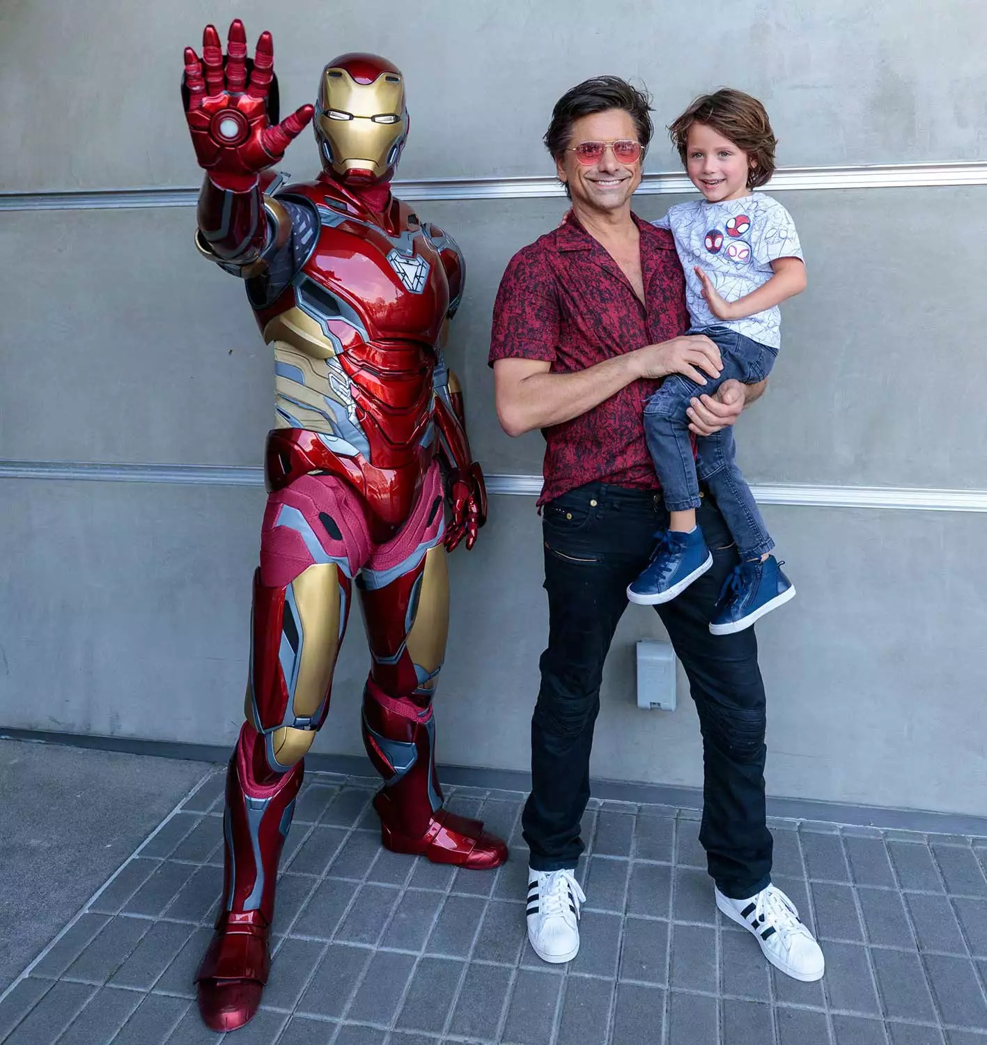 John Stamos and his son pose with Iron Man at Disney California Adventure Park on August 01, 2022 in Anaheim, California. The second season of &ldquo;Spidey and his Amazing Friends&rdquo; premieres on Disney Channel and Disney Junior on August 19, 2022.
