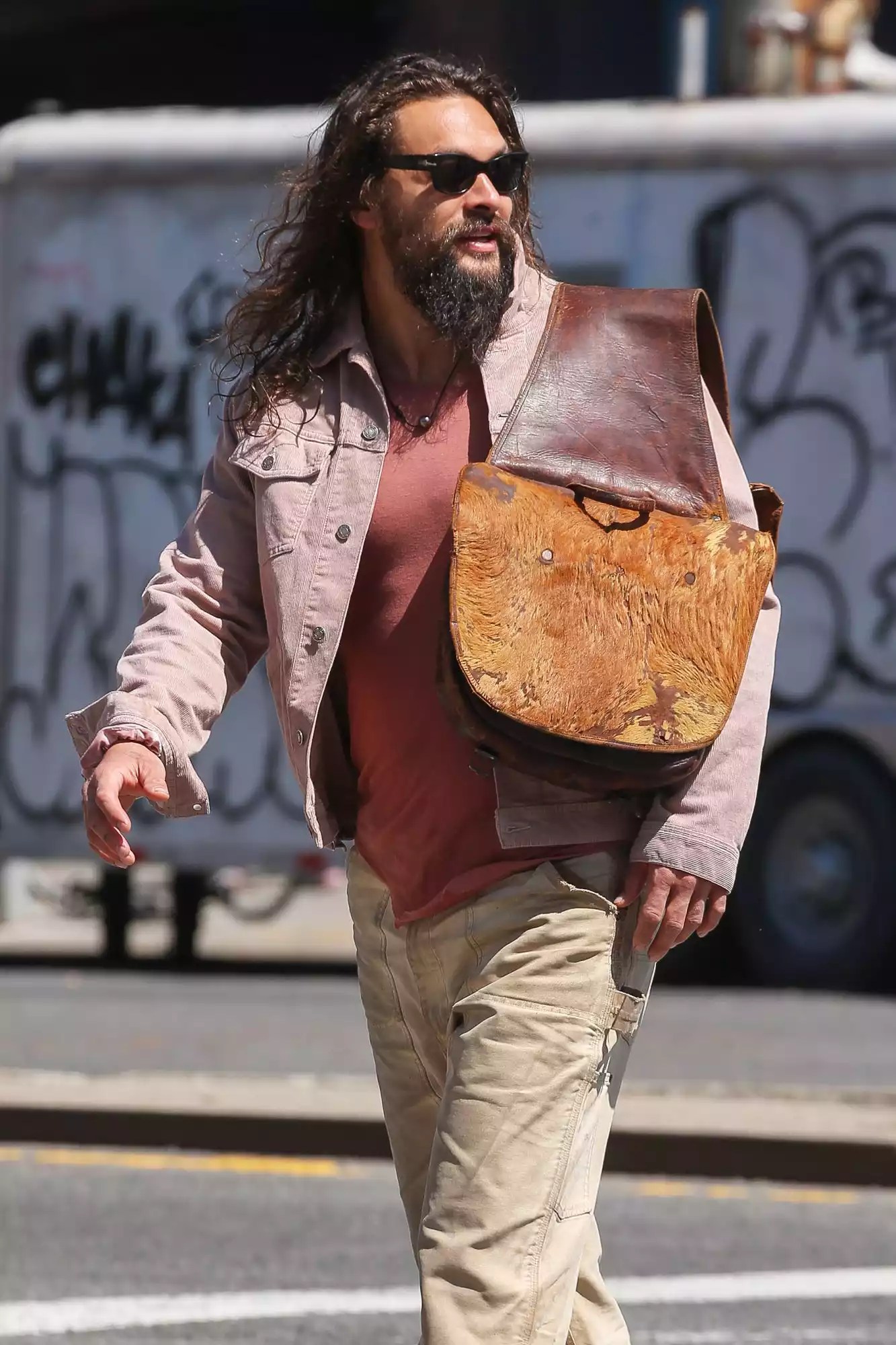 EXCLUSIVE: Jason Momoa Steps Out in New York City Wearing an Unusual Bag on His Shoulder.