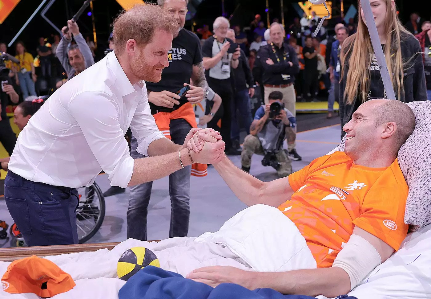 Prince Harry, Duke of Sussex talks to injured member of Team Netherlands basketball team, former Marine Jelle van Der Steen who was operated on last week and brought specially to be able to support his teammates during the Wheelchair Basketball competition during day six of the Invictus Games The Hague 2020 at Zuiderpark on April 21, 2022 in The Hague, Netherlands.