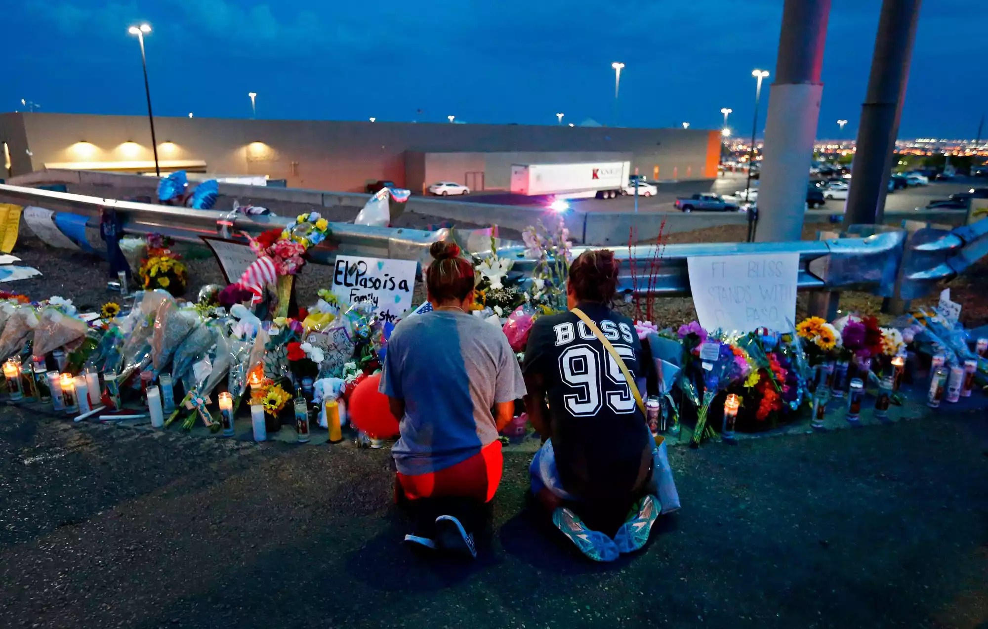 Two women kneel to pray at a make shift memorial at the site of a mass shooting at a Walmart in El Paso, Texas, USA, 04 August 2019