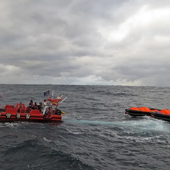 A handout photo made available by the Korean Coast Guard shows members of the Coast Guard engaging in a search and rescue operation in waters 148.2 kilometers southeast of Seogwipo, Jeju Island, South Korea, 25 January 2023, after Jin Tian, a Hong Kong-registered cargo ship carrying 22 crew members, sank off the southern island. Cargo ship sinks between Japan and South Korea, Jeju - 25 Jan 2023