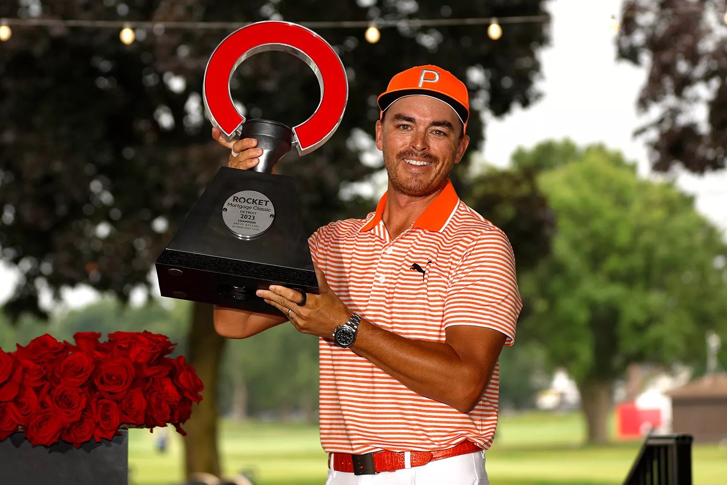 Rickie Fowler of the United States poses with the trophy after defeating Adam Hadwin of Canada and Collin Morikawa of the United States