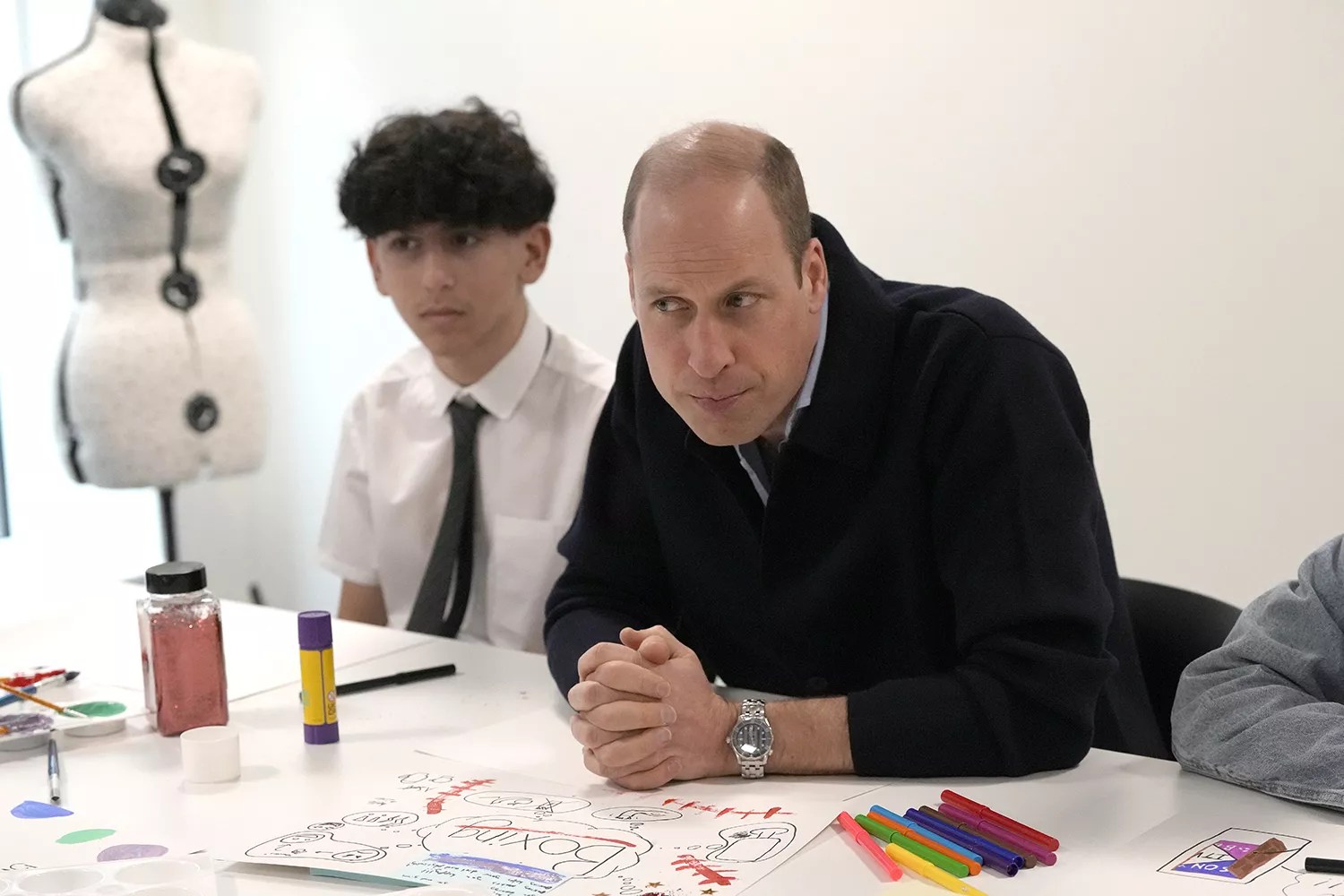 Prince William listens as he interacts with young people during his visit to WEST, the new OnSide Youth Zone in Hammersmith and Fulham in London