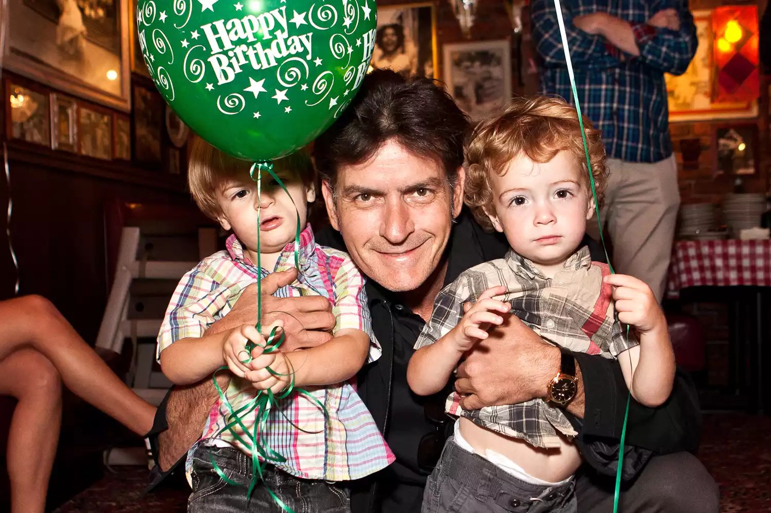 Actor Charlie Sheen poses with sons Max Sheen (L) and Bob Sheen (R) at his birthday celebration with family at Buca di Beppo on September 3, 2011 in Encino, California