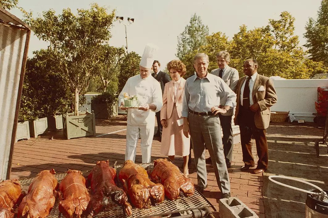 In this photograph, taken May 2, 1979, a group including President Jimmy Carter, Social Secretary Gretchen Poston, and White House Executive Chef Henry Haller inspect the preparations on the West Terrace for a State Dinner to be held for Prime Minister Masayoshi Ōhira of Japan.