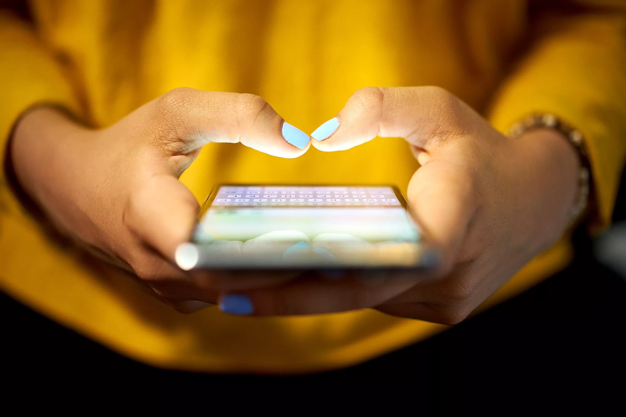 Woman Typing Phone Message On Social Network At Night