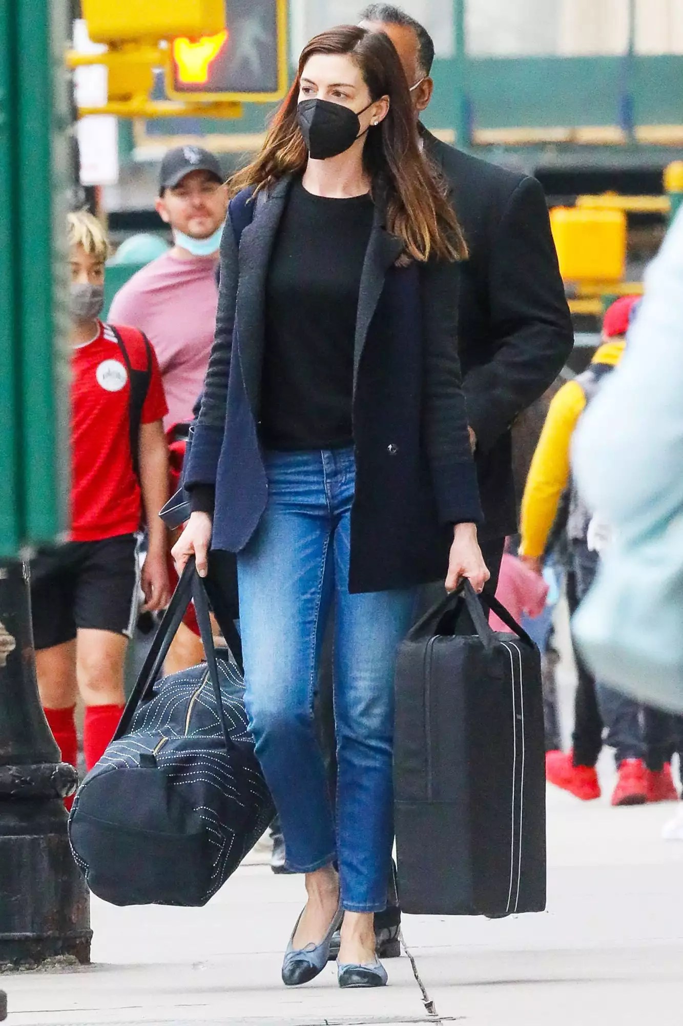 Anne Hathaway Has Her Hands Full As She Carries Her Luggage While Checking Out Of Her Hotel In New York City