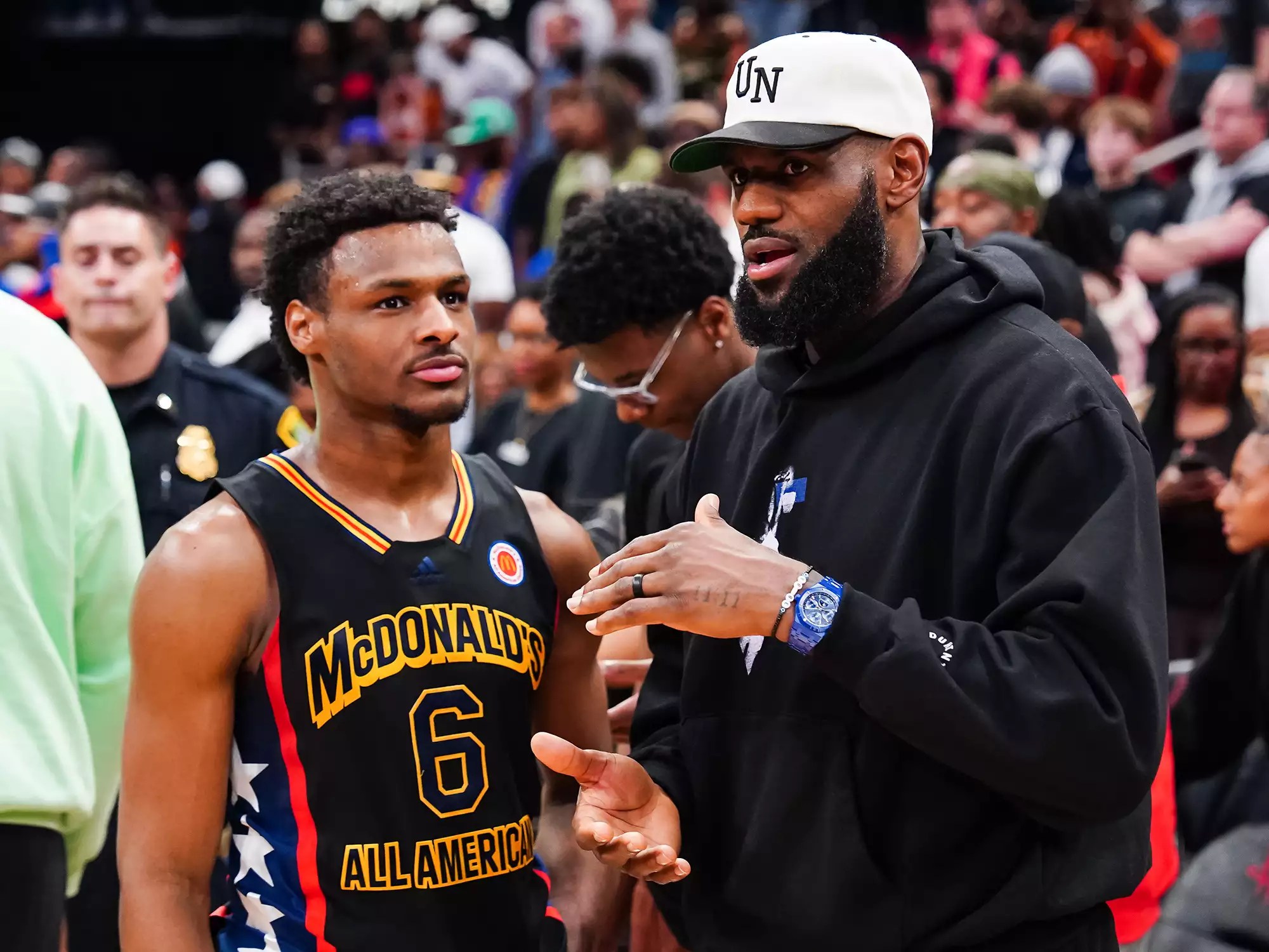 Bronny James #6 of the West team talks to Lebron James of the Los Angeles Lakers after the 2023 McDonald&rsquo;s High School Boys All-American Game